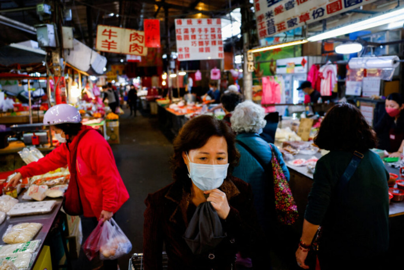 FILE PHOTO: People buy food items at a market in New Taipei City