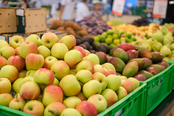 Fresh apples on the market. A lot of fruits on the supermarket counter: apples, mangoes, pears. Vitamins.