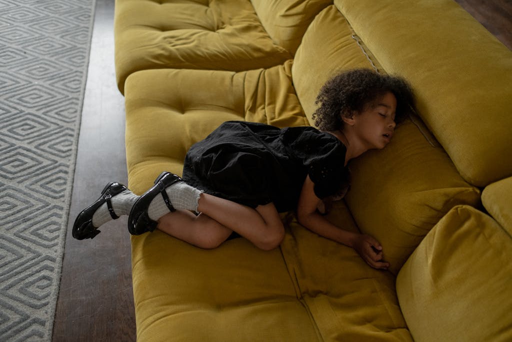 Cute Girl Sleeping on a Yellow Couch